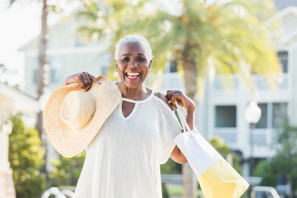 an older woman with sunhat smiles